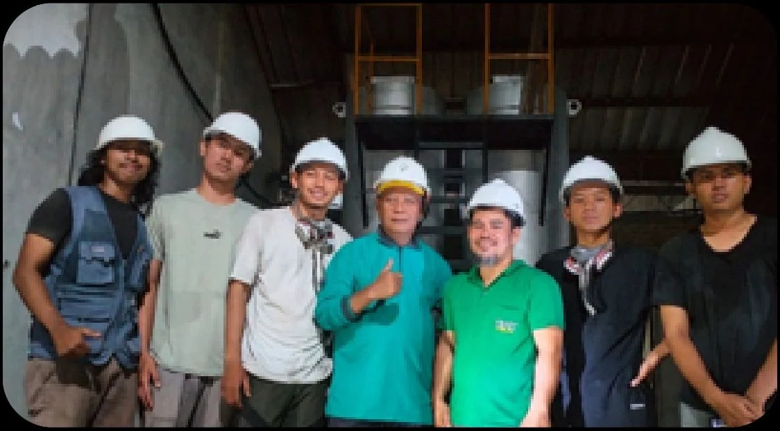 Project team gathered at an industrial reactor